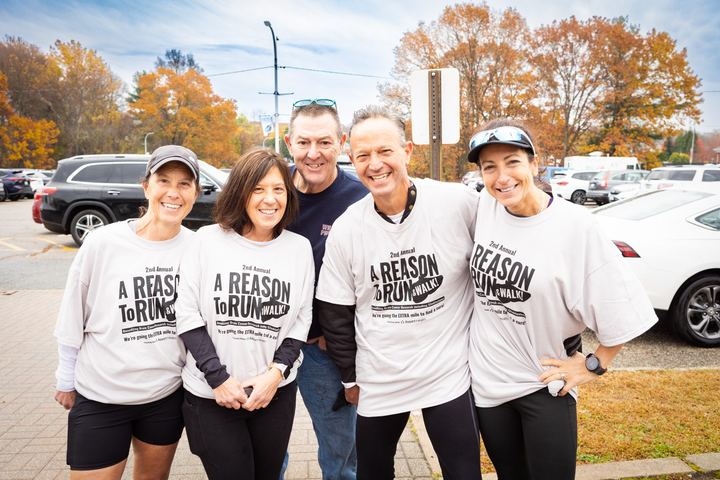 Friends posing together in matching Reason to Run shirts
