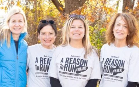 Mandi, Reid, Michelle, and Melissa, the founders of Reason to Run, together outdoors in their event T-shirts